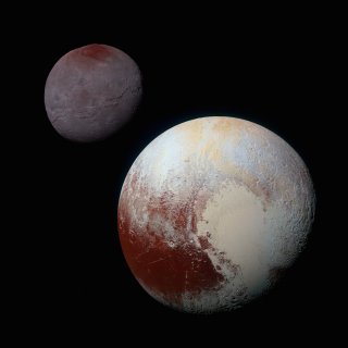 A composite of enhanced color images of Pluto (lower right) and Charon (upper left), taken by NASA's New Horizons spacecraft as it passed through the Pluto system on July 14, 2015. The image combines blue, red and infrared images taken by the spacecraft's Ralph/Multispectral Visual Imaging Camera (MVIC). Credit: NASA/Johns Hopkins University Applied Physics Laboratory/Southwest Research Institute.