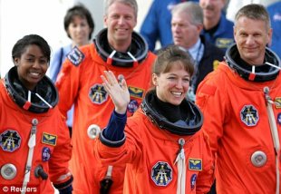 Before it all went wrong: Lisa Nowak, pictured waving, when she was an astronaut with the Space Shuttle Discovery crew
