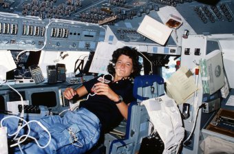 Floating freely on the flight deck, Sally Ride communicates with ground controllers in Houston during her STS-7 mission in June 1983.