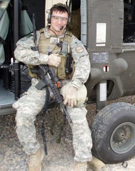 Maj. Andrew Morgan rests on a helicopter in Helmand province, Afghanistan in 2009, where he was supporting a Special Forces mission during a spring offensive. Morgan will begin training as an astronaut candidate with NASA, Aug. 12. (Photo courtesy of Maj. Andrew Morgan)