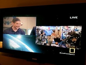 NASA astronaut Mike Hopkins (left) at NASA's Mission Control in Houston chats with fellow NASA astronaut Rick Mastracchio (right in blue shirt) and Japanese astronaut Koichi Wakata while the two men were still floating in weightlessness on the International Space Station. Hopkins returned to Earth on March 10, 2014, but spoke here with the station crew on during the National Geographic Channel's