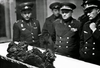 Soviet military officials view the remains of cosmonaut Vladimir Komarov.
